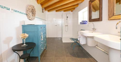 a bathroom with a blue cabinet and a sink at Domaine de Bellac - Le Triangle in Roussines