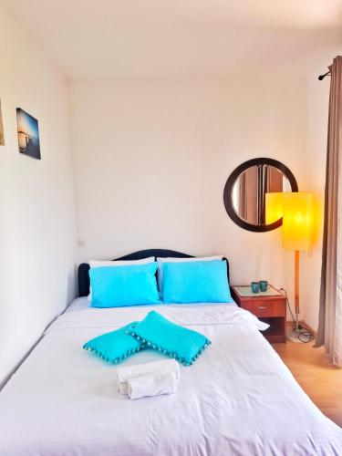 a bedroom with a bed with blue pillows on it at Villa Boris- Next to the Beach with Parking in Ohrid