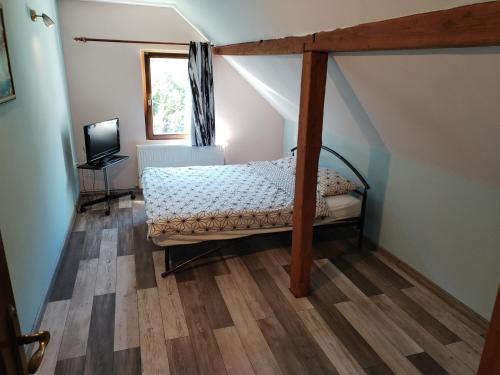a bedroom with a canopy bed in a attic at Casa Sasca Montana in Sasca Montană