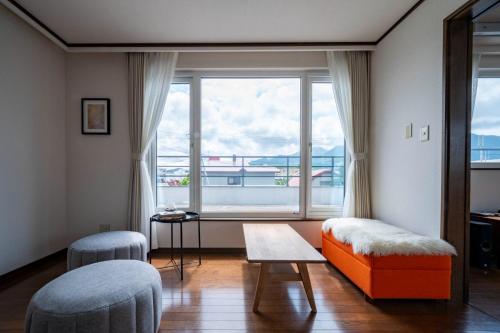 a living room with a large window and a table at SEKKA - Vacation STAY 20179 in Furano