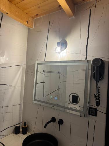a bathroom with a sink and a mirror on the wall at 44 suites Lygia in Paralia Vrachou