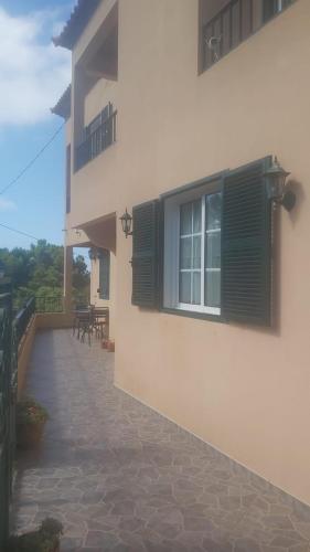 a house with a window and a patio at Abrigo do Monte in Ribeira Brava