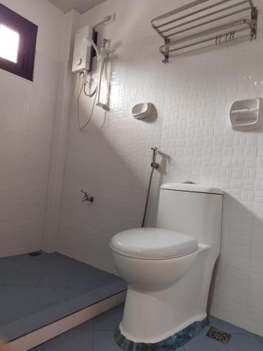 a bathroom with a white toilet in a room at Balancia Guest House 3F unit 5 in Baguio