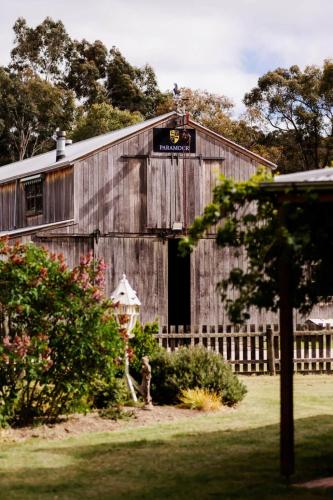 an old barn with an open door in a yard at The Cottage at Paramoor Winery in Carlsruhe