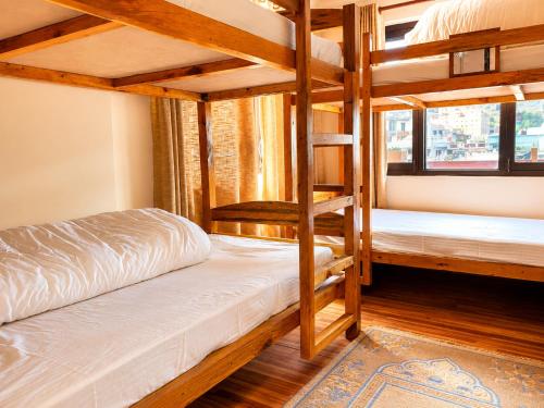 a bedroom with two bunk beds and a window at Birds Nest Hostel in Kathmandu