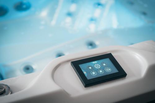 a tablet on the side of a bath tub at Hotel Mauricius in Příbram