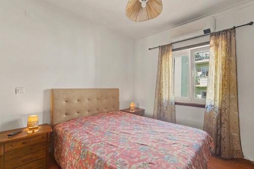 a bedroom with a bed and a window at Azeitão Town House in Azeitao