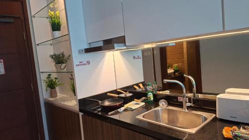 a kitchen counter top with a sink and a sink at wyndham panbil sanctuary in Kangboi