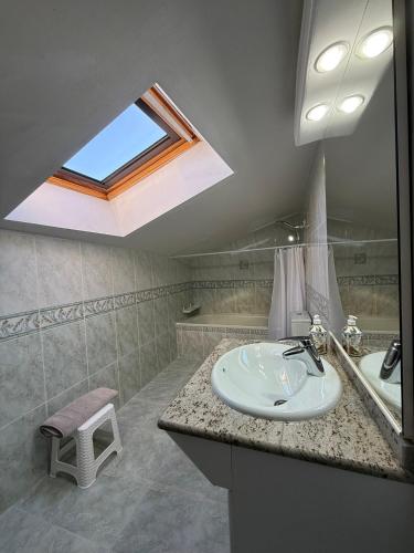 a bathroom with a sink and a skylight at El abrazo de La Yecla in Espinosa de Cervera