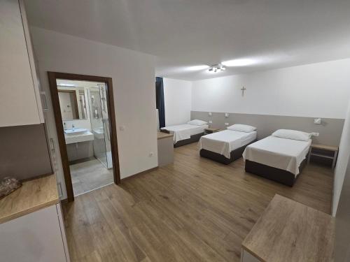 a hotel room with two beds and a bathroom at Hotel 81 in Međugorje