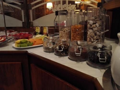 a counter top with food and jars and a plate of food at Hotel Borger in Frankfurt/Main