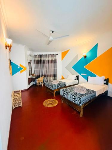 a living room with two beds and a couch at Dickwella Beach in Dickwella