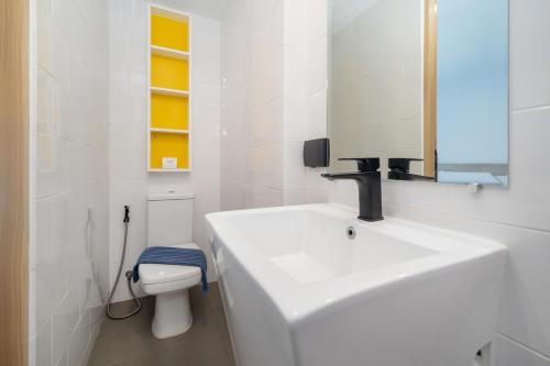 a white bathroom with a sink and a toilet at Relax, Swim & Stay Active in this Duplex - UTL B131 in Rawai Beach
