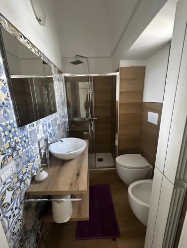 a bathroom with a sink and a toilet and a shower at La Dimora del Colle in Mottola