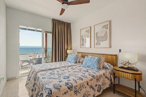 a bedroom with a bed with a view of the ocean at Callao Beach 2 in Arrieta
