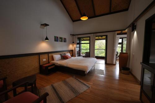 a bedroom with a bed in a room at Red Panda Jungle Camp - A Unit of Davinchi Homes Pvt Ltd in Gyalzing