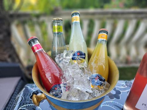 a bucket filled with bottles of soda and ice at Kiki - Emerald River Suite with Private Gardens in Čapljina