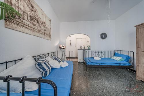 a bedroom with two beds and a couch at Gramsci House - Sea 3 min - Central - Family in Vado Ligure