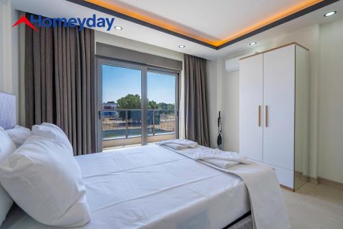 a bedroom with a large bed and a large window at Villa Elyse & Paradise in Orta