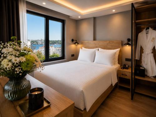 a hotel room with a bed and a window at Art Karakoy Hotel in Istanbul