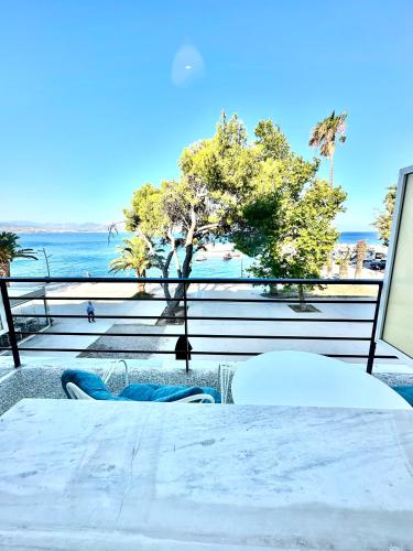 a table and chairs with a view of the beach at Hotel Akti in Loutraki