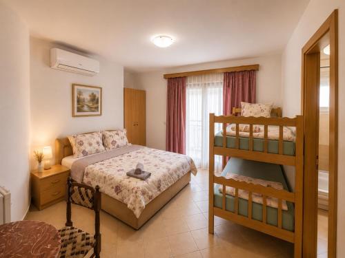 a bedroom with a bunk bed next to a window at Vila Bolonja in Struga