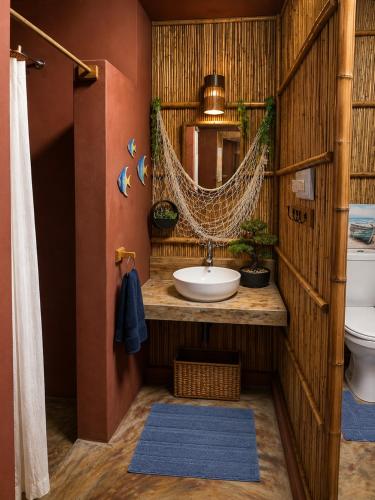 a bathroom with a sink and a hammock in it at Moz Inn - Coconut View Resort in Lopes