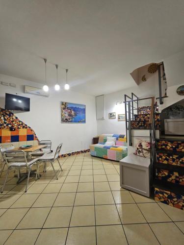 a room with a table and chairs and a couch at CasaFiore Guest House in Vietri sul Mare