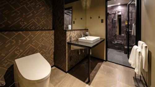 a bathroom with a toilet and a sink and a shower at HOTEL SUI HAMAMATSU by ABEST in Hamamatsu