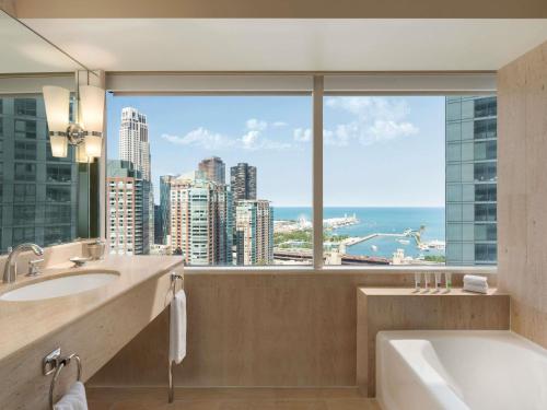 a bathroom with a tub and a large window at Swissotel Chicago in Chicago