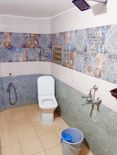 a bathroom with a toilet and a sink at La town beach stay in Pondicherry
