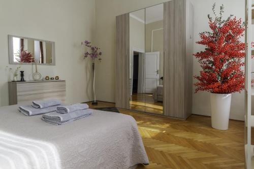 a bedroom with a white bed with towels on it at TONIOLO VENICE ROOMS in Mestre