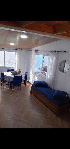 a bedroom with a bed and a table and chairs at Marina in Tipaza