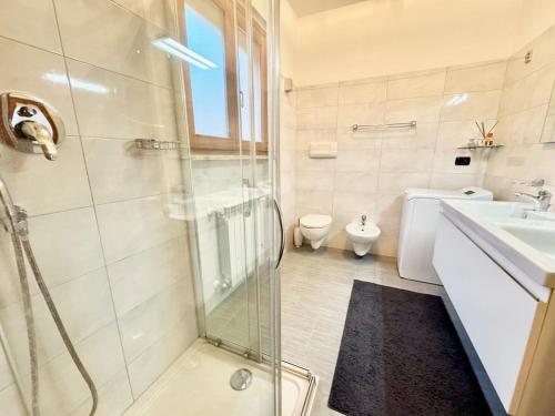 a bathroom with a shower and a sink and a toilet at Appartamento La Perla in Brezzo