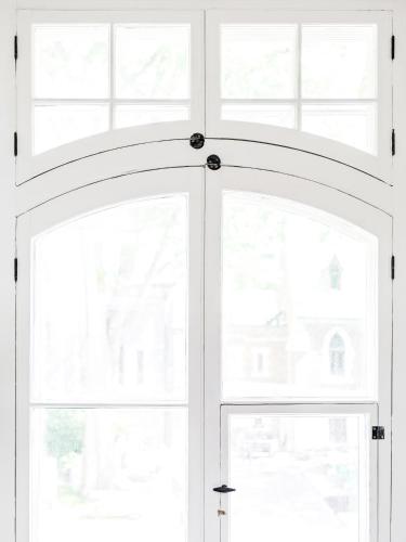 a white door with two windows in a room at C3- Hotel Art De Vivre in Quebec City