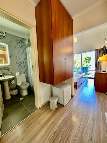 a bathroom with two toilets and a sink at Hotel Akti in Loutraki