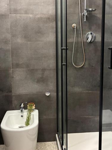 a bathroom with a shower and a toilet and a sink at Nonna Consolata Studio - 25 min to Cagliari & Beaches in Dolianova
