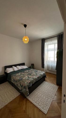 a bedroom with a bed and a large window at Holstentor Apartment in Lübeck