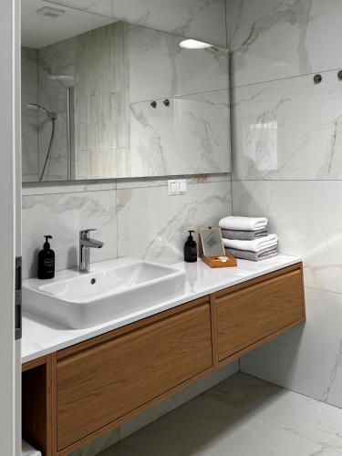 a bathroom with a sink and a mirror at Apartmány Panoráma Bojnice in Bojnice