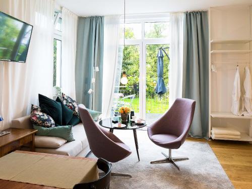a living room with a couch and chairs and a table at Apartment Am Apfelbaum in Reutlingen