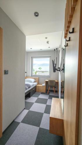 a room with a bedroom with a bed and a window at Rest&Drive in Warszowice