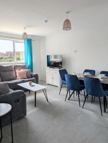 a living room with a couch and a table at Mach House in Campbeltown