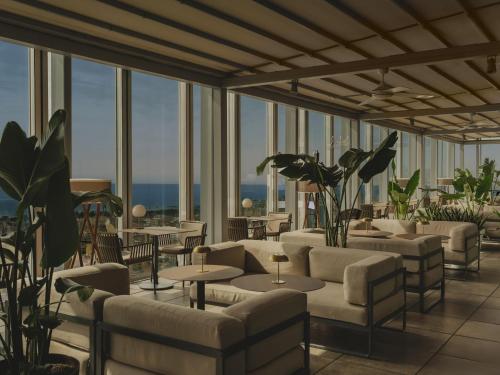 a hotel lobby with couches and tables and windows at The Level at Meliá Barcelona Sky in Barcelona