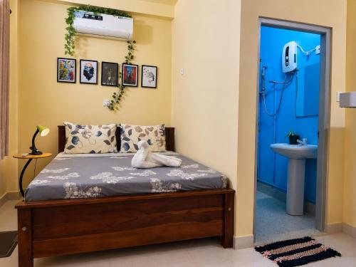 a bedroom with a bed and a blue door at The Don Dock Kandy in Kandy