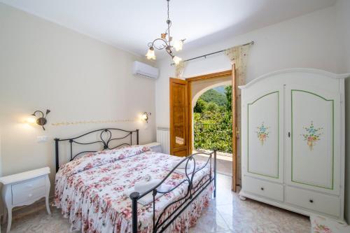 a bedroom with a bed and an open door at Il Vigneto in Tramonti