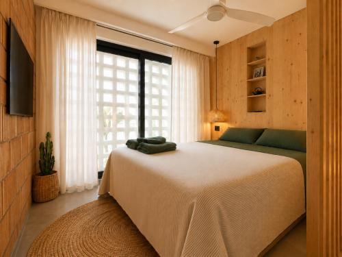 a bedroom with a large bed and a large window at Viviendas El Tiburón in Almerimar