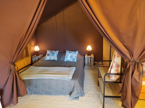 a bedroom with a bed in a tent at clos du loguy in Pénestin