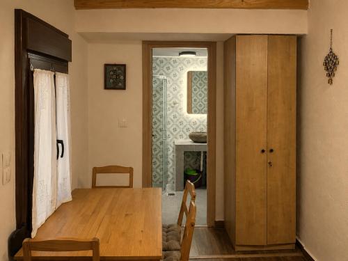 a dining room with a table and a glass door at Meliti Home in Therma