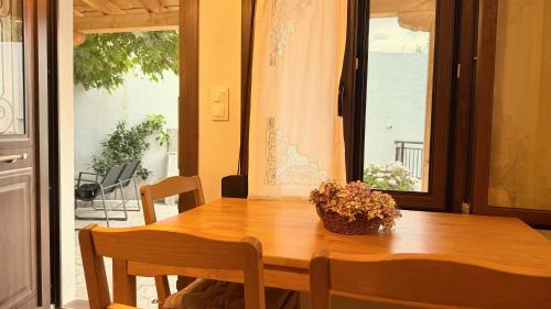 a dining room table with a basket of flowers on it at Meliti Home in Therma