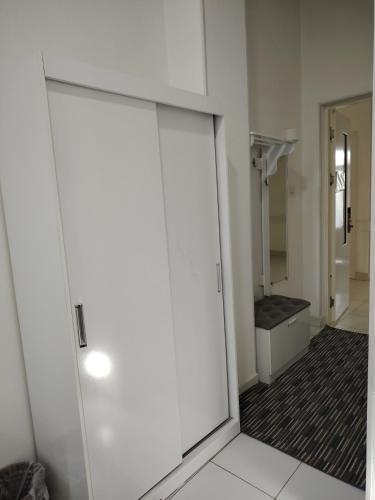 a sliding door in a bathroom with a shower at Chevrolet Hotel in Namangan
